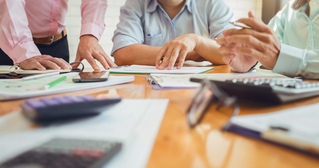 Group of professionals sitting around a conference table